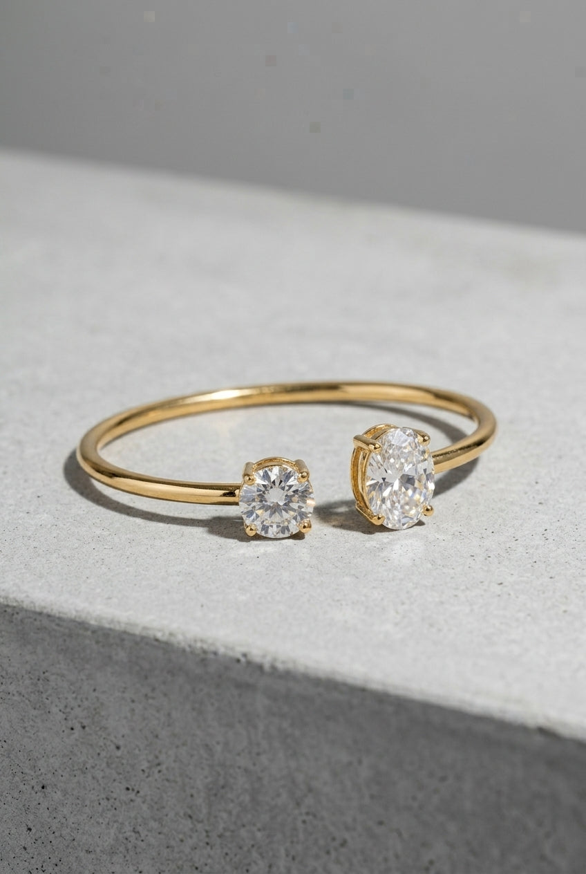 Gold ring with diamond studs on a gray surface