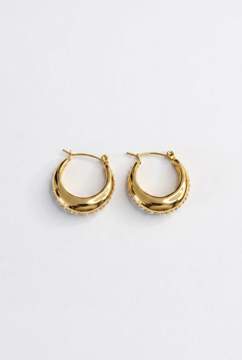 Gold hoop earrings on a white background